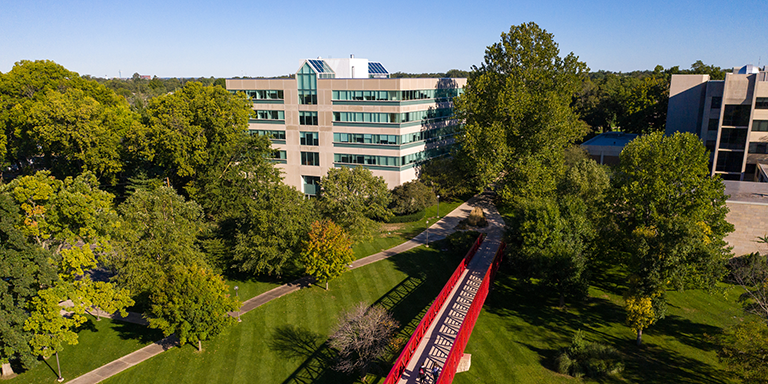 IU South Bend photo flying over main campus red bridge during a sunny day.